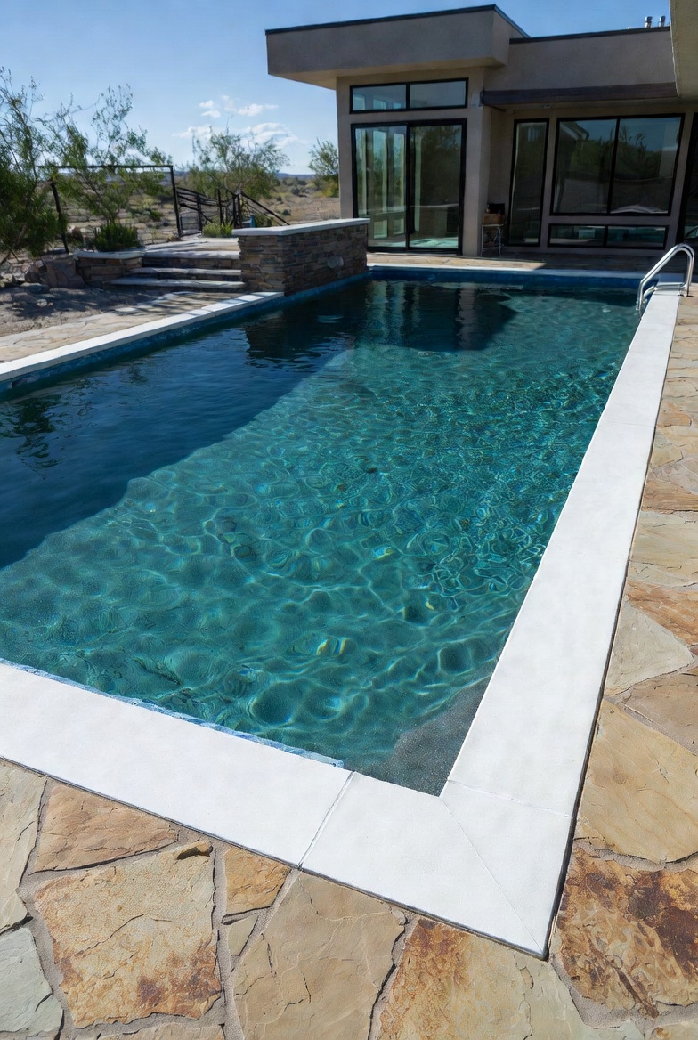 Stone coping and flagstone deck around a St. George pool