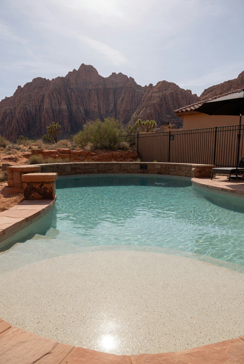 Quartz finish pool in St. George with Snow Canyon red rock cliffs in the background
